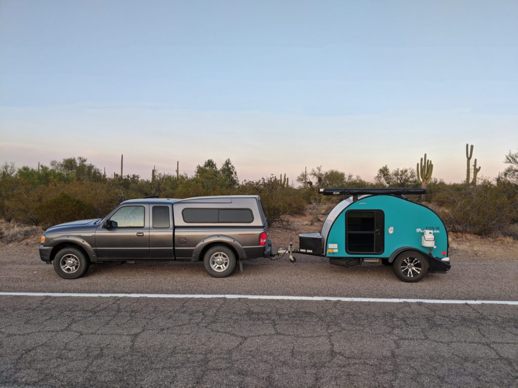 Eva's car in Arizona with her turquoise Evolve Traverse Lightweight Teardrop Camping Trailer